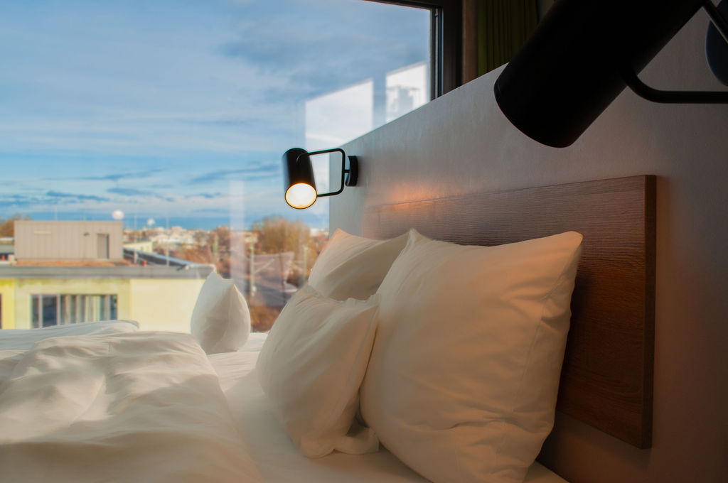 Close-up of the pillows and headboard beside the window