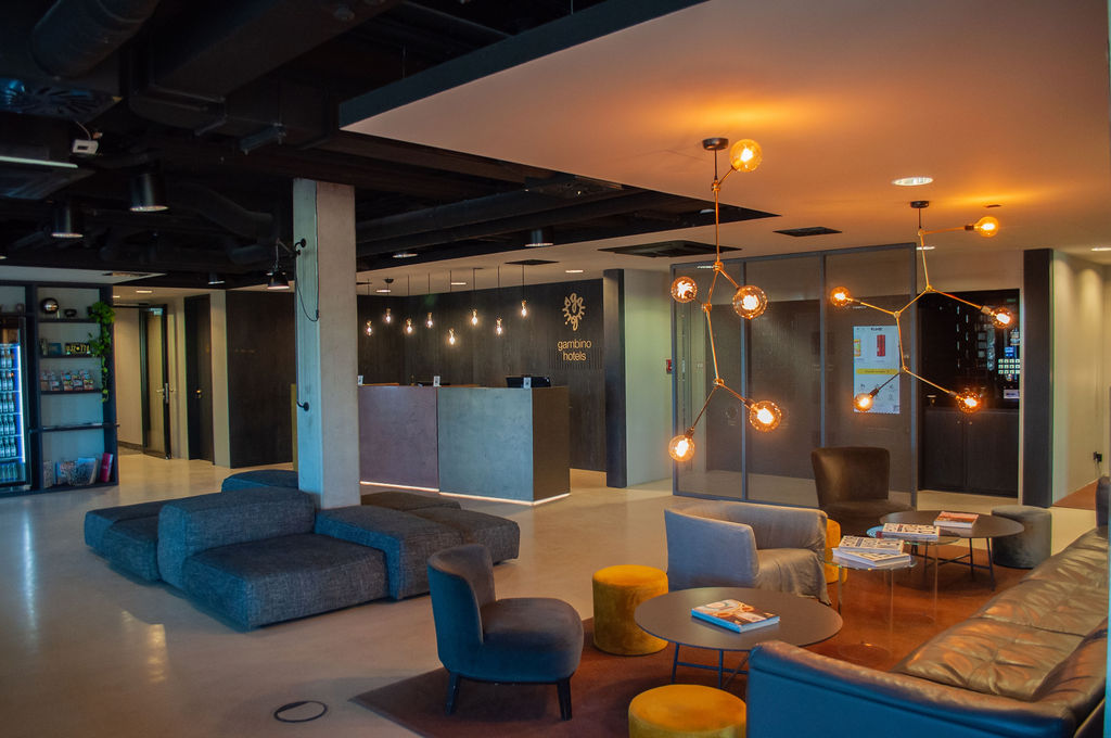 Lobby lounge with armchairs, poufs and pendant lighting